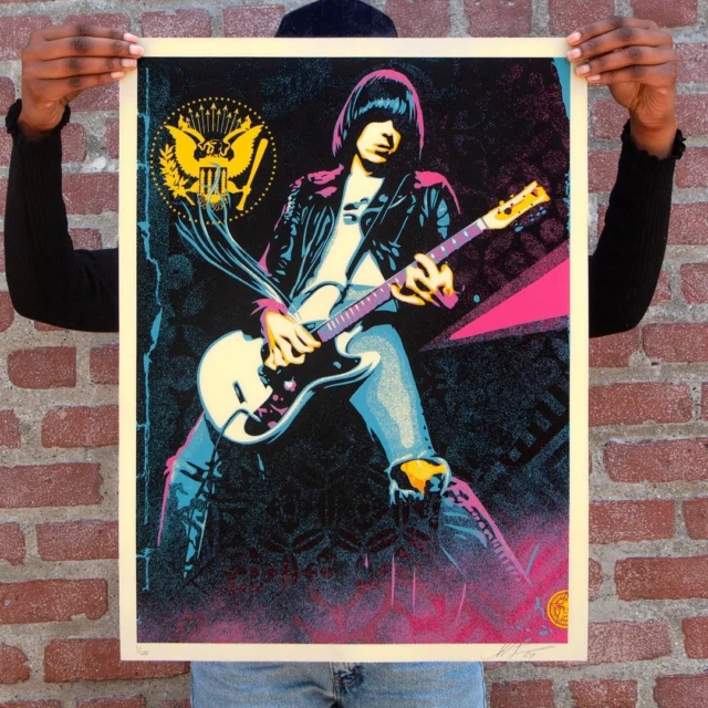 NEW Print Release: "Johnny Ramone Smokin' Strings" Available Thursday, June 13th @ 10 AM PT! 

At the invitation of my friend @LindaRamone, I was honored to design the flyer for and DJ at the most recent @JohnnyRamone tribute, which also screened the movie Pulp Fiction, one of my favorites. Linda liked the flyer design a lot and suggested I make a new illustration of Johnny Ramone based on the image, which incorporated smoke coming off of Johnny’s strings as a nod to his shredding playing and the smoke from Uma Thurman’s cigarette in the Pulp Fiction poster. I’m very happy with how the art poster turned out. I first got into the Ramones in 1984, and they quickly became one of my favorite groups of all time. I saw them live in 1988 and 1989, and the shows featured non-stop blistering action.⁠
⁠
The Ramones show I saw in the fall of 1988 at the Living Room in Providence R.I. was one of the most intense I’ve ever seen. The Living Room should have held 500, but in Providence, clubs paid off the cops, and there were probably 1,000 people in the venue. Jane’s Addiction opened up and raised the energy level. When the Ramones came on, the crowd was ready to go nuts. I was near the stage, and the crowd surged forward, compressing everyone so tightly that I thought my ribs would be crushed. I could pick my feet off the ground simultaneously without using my hands. The Ramones played non-stop, with no breaks between songs for about two hours. The band was super tight. Johnny leaned into the crowd and didn’t even take his leather jacket off for an hour, even though it was sweaty as hell in there. Joey’s hair was in his eyes, but he stayed planted in front of the mic and sounded great. At certain points, I felt like I was going to suffocate or be crushed, but I refused to give up my spot right at the front. It may seem weird to say you are having the time of your life fighting for your life, but that’s the only way I can describe that show.⁠
-Shepard⁠
⁠
Half of the edition will be sold on obeygiant.com and half on johnnyramone.com⁠
⁠
(see print details below)