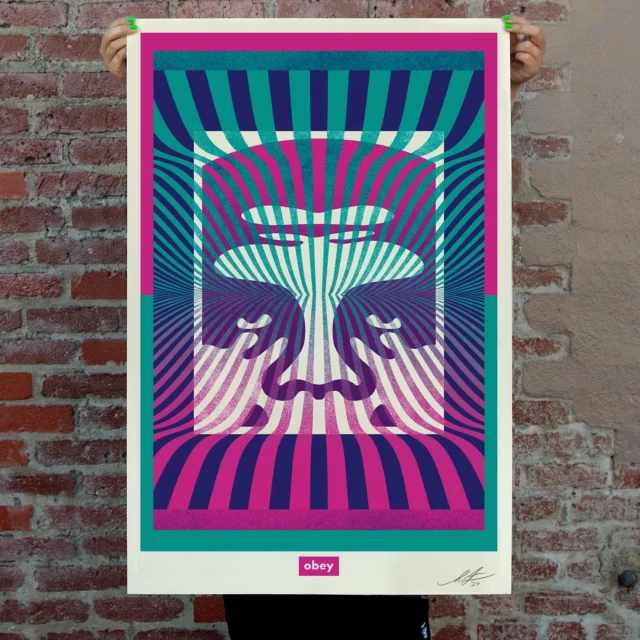 My Op Art Icon offset print is nostalgic in some ways and of the moment in others. Here’s the story - In the early ‘90s, I fell in love with ‘60s psychedelic posters from artists like San Francisco’s Victor Moscoso, Stanley Mouse, Alton Kelley, Rick Griffin, and LA’s John Van Hamersveld. I was especially drawn to the op-art patterns and color theory used in psychedelic art. I had been making black and white Andre stickers for a couple of years. I decided it was time to branch out with some playful backgrounds and color theory, so I began experimenting with op-art patterns and intense vibrating colors. Part of the fun was the journey of improving at color theory, and the other part was seeing the polarizing reactions to the psychedelic Andre stickers. This image relates to my early ‘90s explorations but pushes a lot further with the way the colors weave through the Icon Face image and have the effect of subtle translucency through the spray paint texture. I always have fun finding new ways to use some of my staple images, like the Icon Face, because repetition with evolution is an important principle for the Obey Giant campaign. - Shepard

**PRINT DETAILS:**
Op Art Icon Offset. 24 x 36 inches. Offset on 80# Natural White Cougar Smooth paper. Signed by Shepard Fairey. $35. Max order: 1 per customer/household. International customers are responsible for import fees due upon delivery (Except UK orders under $160).⁣ ALL SALES FINAL.