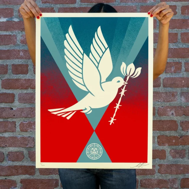 This Barb Wire Dove Gradient screen print is based on the Peace Dove, a motif I’ve used in several iterations over the years, because as an icon, the dove is internationally recognized as a symbol of peace, making it ideal as a communication tool. With the wars going on in the world, a message of peace is more important now than ever. The peace dove includes a flower growing from the barb wire, symbolizing positive growth from an oppressive situation. In this version of the Barb Wire Dove, I’ve explored a new color and placement by having the gradient of red with spray texture into the blue rays up toward what could be interpreted as the sky to depict the dove rising above the darkness and into a more positive future. Thanks as always for your support.
- Shepard

PRINT DETAILS:
Barb Wire Dove Gradient. 18 x 24. Screen print on 80# cream Speckletone paper. Signed by Shepard Fairey. Numbered edition of 275. Comes with a Digital Certificate of Authenticity provided by Verisart. $65. A portion of the proceeds will be donated to Doctors Without Borders. Available on Tuesday, December 3rd @ 10 AM PDT at Obey Giant. Max order: 1 per customer/household. International customers are responsible for import fees due upon delivery (Except UK orders under $160).⁣ ALL SALES FINAL.