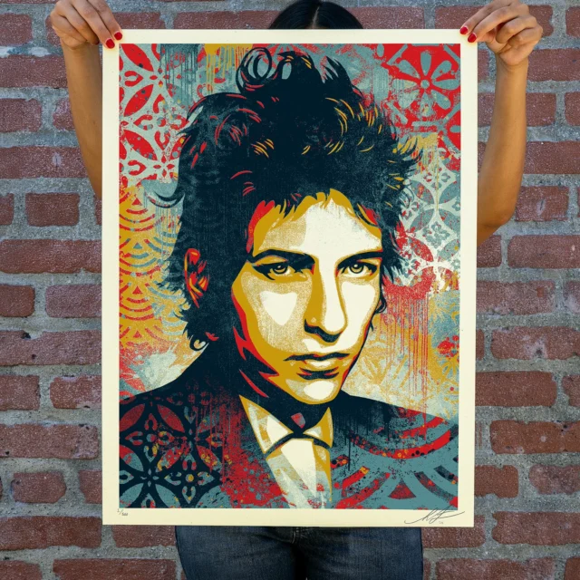 I’ve been a Bob Dylan fan most of my adult life, but I’m far from being obsessive. Dylan has a huge catalog, but a good bit of it is not in the sweet spot of my taste. However, the good stuff is REALLY good and much of it is incredibly important to the evolution of modern music. I made a portrait of Dylan in 2010, and I thought that maybe that’d be enough. I sometimes forget how significant Dylan is, but watching the biopic “A Complete Unknown” was a re-invigorating jolt not only for my admiration of Dylan, but my belief that art can shape ideas and influence culture. Dylan’s protest, or at least social commentary songs, are astoundingly powerful. Dylan is incredible with words and serves as the people’s poet in his best work. The examples are many, but some of my favorite Dylan songs are The Times They Are A-Changin’, Masters of War, Hurricane, Subterranean Homesick Blues, With God on Our Side, and this print’s namesake... A Hard Rain’s A-Gonna Fall. Check out just some of the Hard Rain’s lyrics:
Oh, what did you see, my darling young one?
I saw a newborn baby with wild wolves all around it
I saw a highway of diamonds with nobody on it
I saw a black branch with blood that kept drippin’
I saw a room full of men with their hammers a-bleedin’
I saw a white ladder all covered with water
I saw ten thousand talkers whose tongues were all broken
I saw guns and sharp swords in the hands of young children
And it’s a hard, and it’s a hard, it’s a hard, it’s a hard
And it’s a hard rain’s a-gonna fall
The lyrics, like all poetry have latitude for interpretation, but if they don’t make you feel something for the state of our world, then I question your humanity. The best art is timely AND timeless which is hard to pull off, but is emblematic of Dylan’s best work.
This image is based on a photo by Daniel Kramer, who shot Dylan regularly during his rapid mid-60s ascent to stardom and audience projection of Dylan as the voice of a generation… a label Dylan was quick to resist. Dylan rose to the moment but abhorred public expectation and pressures. I think this image captures both his self-possession and reticence.
-Shepard
(Avail on 2/27 at 10am PT. More details in comments)