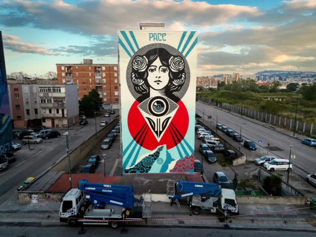 This “Third Eye Open Peace” mural in Naples incorporates a portrait I originally made for my Make Art Not War print back during the Iraq War. The mural is a public art companion piece to my “Power To the Peaceful” exhibition opening at @gallerieditalia on May 6. I have long promoted peace through my art and activism and this mural incorporates a peace sign and peace text (PACE in Italian) while also including a third eye blooming like a flower, The third eye represents a dialogue with one’s inner self, higher consciousness, and a quest for enlightenment, all of which are essential to achieve peace and harmony. I’ve often used the phrase “eyes open-mind open” and I think “third eye open” is a similar but slightly weightier idea because it addresses looking not only outward to observe, but inward as well. If we can connect with our own humanity we can have empathy for others. Thank to the sponsors @poltronafrauofficial, @lareggiadesigneroutlet, and @montana_colors for helping make this all happen. Also, big thank you to @culturanapoli, @wunderkammerngallery, and @inwardcreativitaurbana, and my team @dfloreal @zagnutz, and @jonathanfurlong for all of your hard work this week! -Shepard

Photo by: @jonathanfurlong