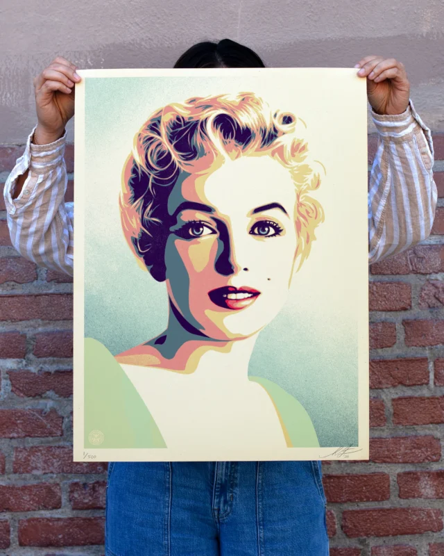 Marilyn Monroe has fascinated me since I was a child. I was probably ten years old when I asked my dad, “Why is Marilyn Monroe so famous?” He answered something like “well, she was a symbol of American beauty and hope. She burned bright but tragically died young.” I was intrigued and watched Marilyn’s movies whenever they showed on cable. Seeing her on screen, I was mesmerized by her allure, her humor, and her vulnerability. I might not have been able to articulate it as a young person, but Marilyn had range and nuance that was magnetic, and I leaned in. Later in high school, I became interested in pop art, and one of the genre’s most famous series of images is Andy Warhol’s Marilyn portraits. Warhol’s Marilyns are superb in their use of color and effectively achieve his goal of reducing her to a high-contrast iconic, but impersonal representation. However, iconic glamour is only one dimension of Marilyn. When I was presented with the opportunity to make art of Marilyn based on photos by Milton H. Greene from 1956, when she was at the height of her powers, I was struck by the images’ intimacy and vulnerability. To me, these images called for a much more delicate approach compared to Warhol’s in order to convey more nuance and humanity. Even though Marilyn showed courage and conviction fighting for civil rights, equality, and against McCarthyism, her mental health struggles are widely recognized. I felt it was important to depict her precarious dance between wide-eyed aspiration and shying away from the glare of the spotlight. I hope these images, “Marilyn Sunrise” and “Marilyn Sunset,” inspire an empathetic look at Marilyn’s complex humanity and remind us that we are all teetering between strength and fragility.
-Shepard

PRINT DETAILS: Marilyn Sunset OR Marilyn Sunrise. 24”x18”. Screenprint on 80# cream Speckletone paper. Signed by Shepard Fairey. Numbered edition of 500. Comes with a Digital Certificate of Authenticity provided by Verisart. $100. A portion of the proceeds will be donated to The #MarilynMonroe Mental Health for the Arts Program. Avail on Thurs, 5/14 @ 10AM PT at Obey Giant Store. A limited amount of sets will be avail for $200.

#IconicMoments
